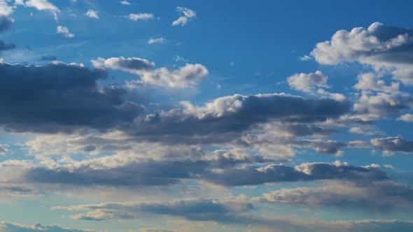 Cumulus Rain Cloud Formations in Open Air Float Along Sky alt