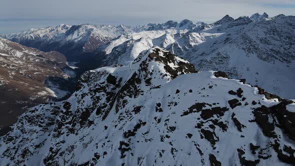 Aerial View of Cheget Mountain Range in Snow in Winter in Sunny Clear Weather alt