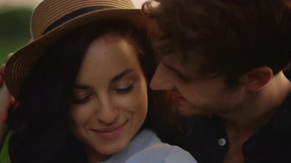 Guy Hugging Girl Behind in Park. Smiling Couple Expressing Tenderness Outdoors alt