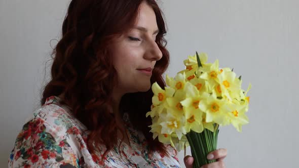 Portrait of Young Romantic Smiling Beautiful Woman Girl Sniffing Smelling Yellow Daffodils Flowers