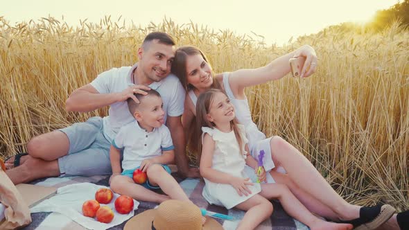 Mom Taking Family Selfie at Picnic in Field alt