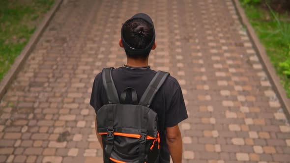 Unrecognizable Traveller Walks in Town alt