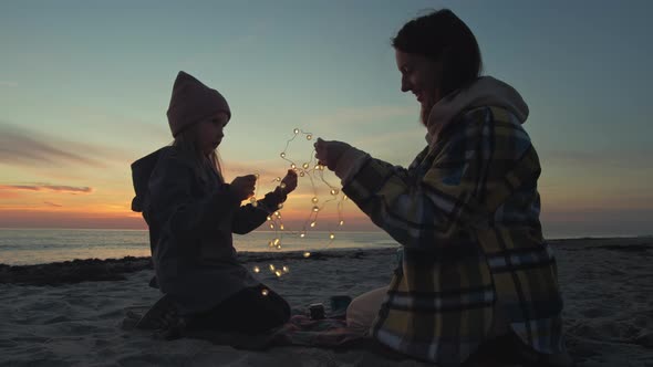 Mother celebrate with daughter on the beach alt