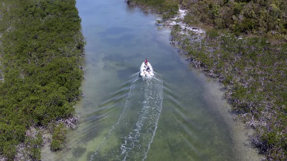 Tourists On The Motorboat Sailing Between The Mangrove Forest In Bahamas. aerial alt