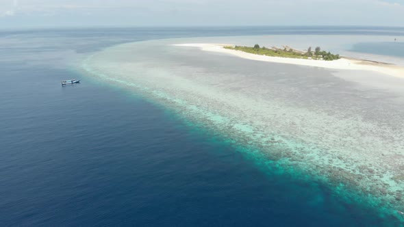 Aerial: Flying over idyllic atoll, travel destination Wakatobi Indonesia alt
