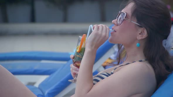Pretty Young Female Relaxing With Fresh Cocktail on Sunny Beach alt
