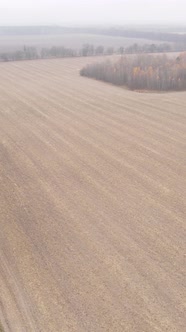 Vertical Video of a Field with Plowed Land in Autumn Slow Motion alt