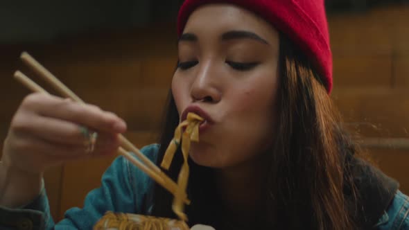 Teen Girl Eating Noodles Close-up alt