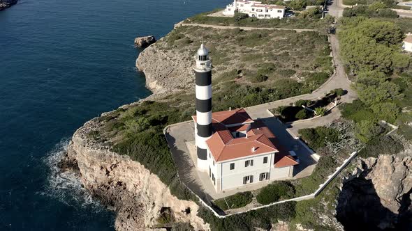 Portocolom lighthouse on cliff at the sea, Mallorca, Spain alt