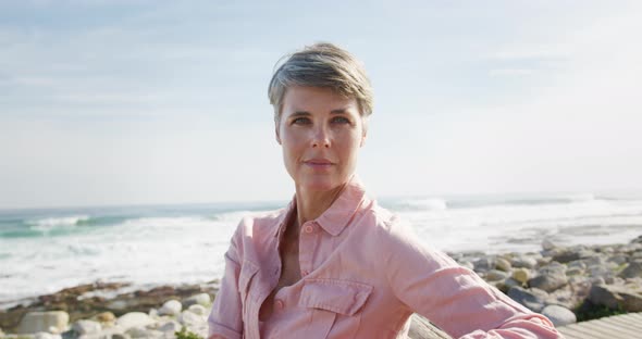 Portrait of a Caucasian woman enjoying free time by the sea on a sunny day alt