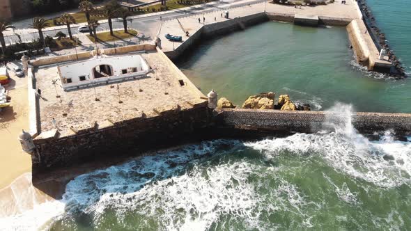 4k aerial drone footage of a tide pool off the boardwalk of Lagos, Portugal alt