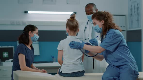 Woman Nurse Using Stethoscope to Check Pulse and Heartbeat alt