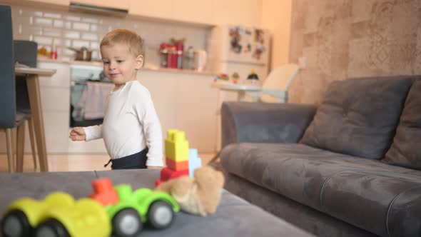 Little Happy Cute Baby Toddler Boy Blonde Playing with Constructor