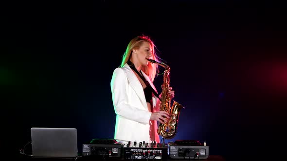 Young Sexy, Blonde Woman Dj in White Jacket Playing Music Using Saxophone on Black alt