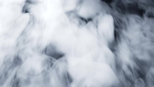 Dry Ice Clouds Overlay Background. White Abstract Smoke Slowly Floating Through Black Surface alt