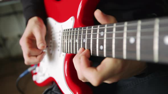 A Male Hand While Playing an Electro Acoustic Guitar
