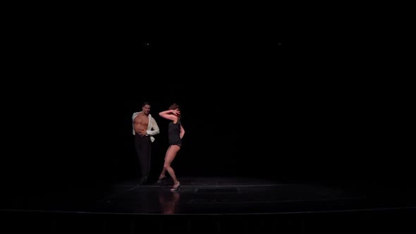 Young Ballroom Dancers Couple on Dark Stage Dancing Latin American Program Dancehip Rotations
