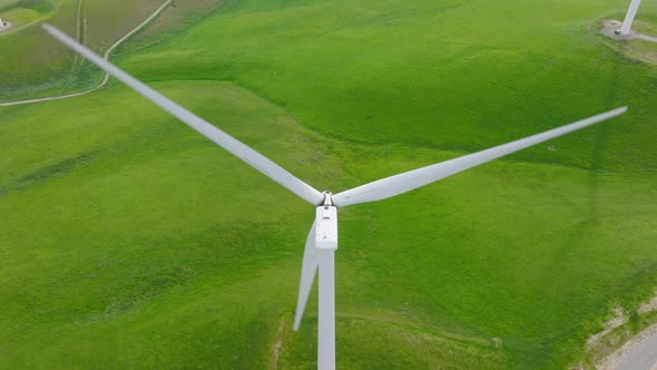 Beautiful White Wind Turbine on Scenic Green Hill Renewable Sustainable Energy alt