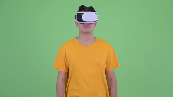 Happy Young Multi Ethnic Man Using Virtual Reality Headset alt