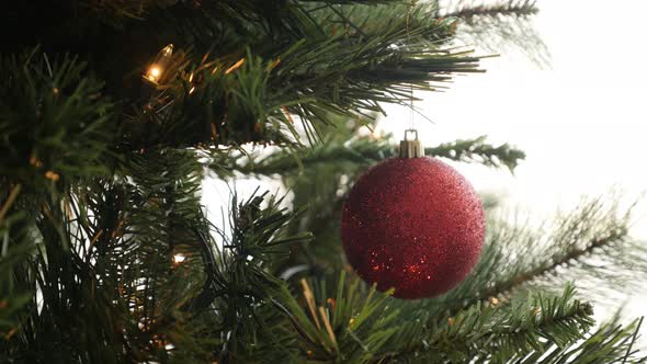 Christmas ornament hanged on the artificial tree 4K 2160p 30fps UltraHD footage - Red bauble with se alt