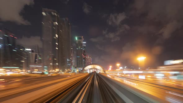 Time lapse of car light trails on road or street in Dubai Downtown skyline and highway, United Arab