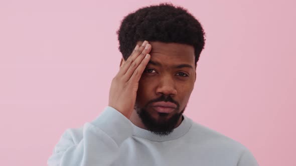 Handsome African man correcting his appearance at the camera alt