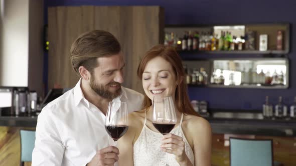 Couple relaxing together with red wine