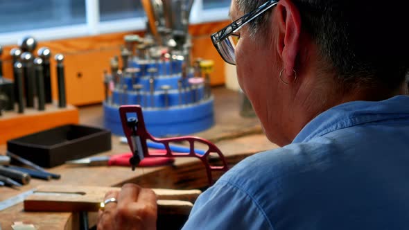 Craftswoman working in workshop alt