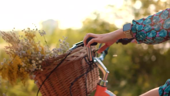 Girl In Hat Enjoying Weekend. Woman Cyclist Walking With Bike On Holiday Vacation Trip. Wildflower. alt
