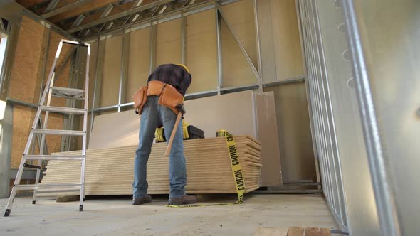 Construction Worker and the Construction Site. Steel Frame House Building. alt