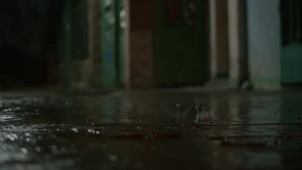 Closeup at Night Drops of Summer or Autumn Rain Fall on the Asphalt in the City Near Residential alt