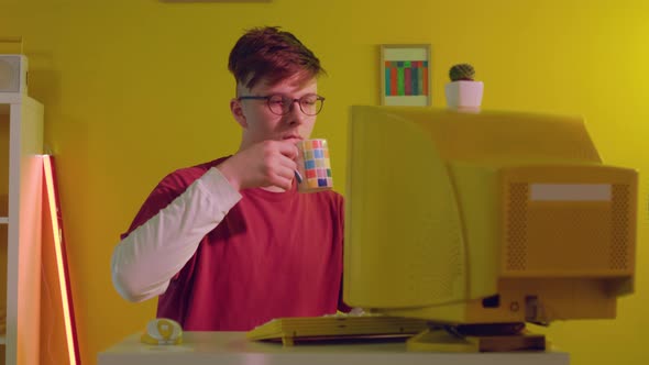 Man Is Working at PC and Drinking Tea
