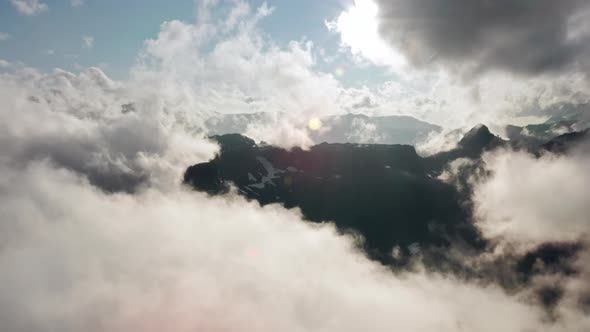 Drone Flying Through Thick Fog Above Beautiful Mount Baker Wilderness at Sunset alt
