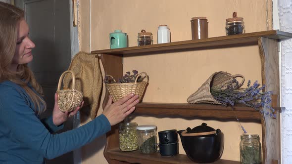 Herbalist Woman Prepare Dried Herbs in Wicker Baskets for Winter Time
