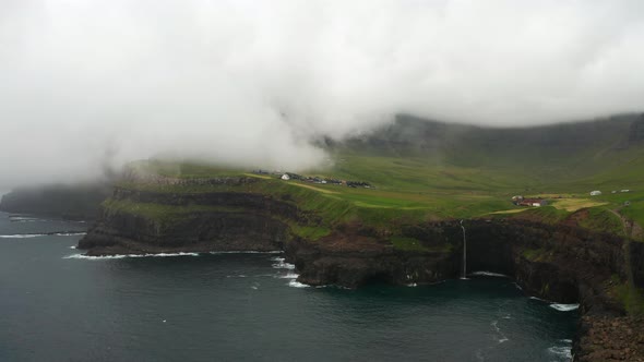 Sunset View of Mulafossur Waterfall and Gasadalur Village alt