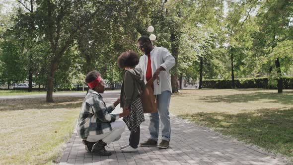 Happy African-American Family of Three Outdoors alt