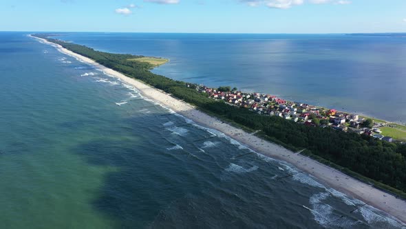 Beach in beautiful city Chalupy resort in Poland. Aerial video. Baltic Sea.Waves coming in. alt