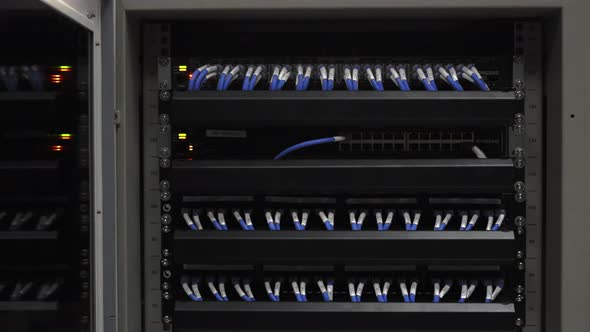 Network switch in data center rack with LED status blink