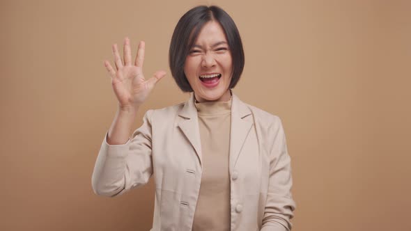 Asian business woman show counting numbers with fingers and smiling isolated