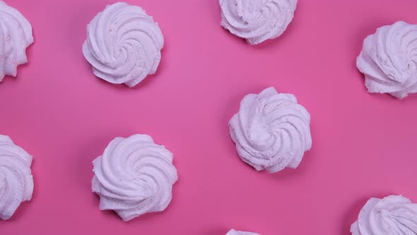 Rotating Background of Marshmallows or Cakes Birthday Cakes on a Pink Background