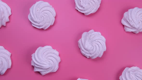 Rotating Background of Marshmallows or Cakes Birthday Cakes on a Pink Background alt