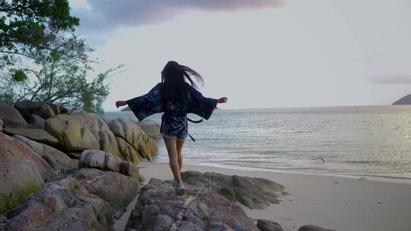 Cute Asian Girl in Kimono Walking on a Rock at Sunset in Slow Motion Thailand