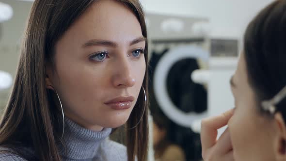 Makeup Artist Combs the Model's Eyebrows
