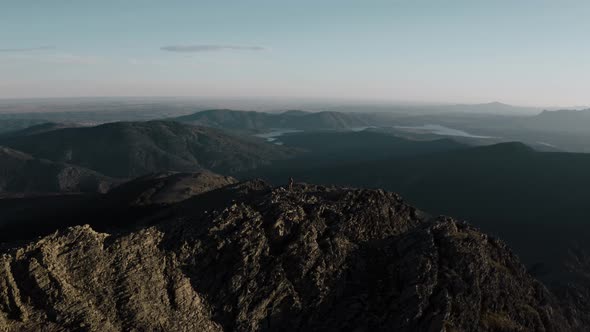 Hiker standing on ridge of Puebla de la Sierra mountains, Spain alt