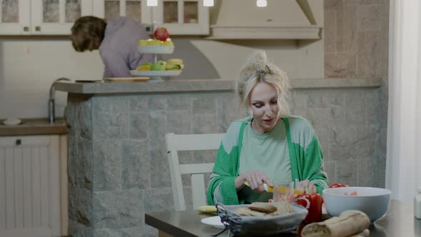 Happy active family couple preparing food at home. alt