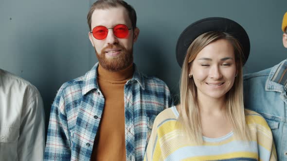 Portrait of Joyful Young Businesspeople Standing Against Black Color Background Smiling alt