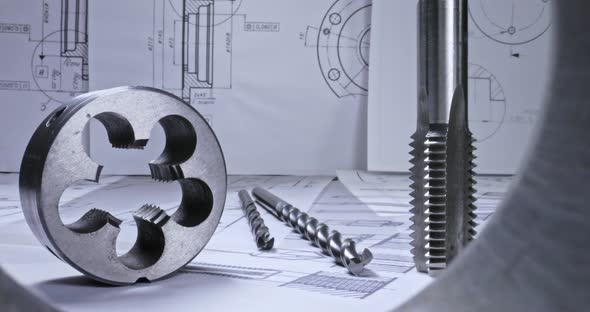 Designer desk of mechanical parts. Mechanical diagrams, bearings and drill. alt