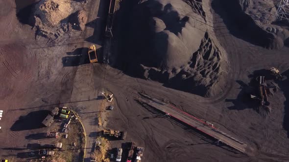 Dump Truck Driving Between Pile Of Petroleum Coke Storage At Zug Island In Detroit, Michigan, USA. - alt
