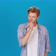 Young Man Calls to Keep Mouth Shut on Blue Background - VideoHive Item for Sale