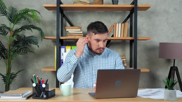 Businessman looking at laptop puts on earphones connect online videocall meeting alt